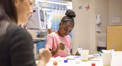 Child life specialist and a patient during art therapy