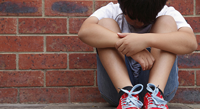 stock image of a child with his head down