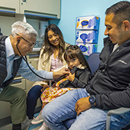 Frank Ing with pediatric cardiology patient Grace and her family