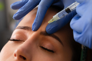 Doctor injecting medicine into the forehead (c) UC Regents. All rights reserved.
