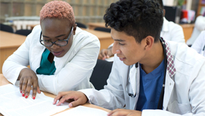 Young doctors looking at documents (c) UC Regents. All rights reserved.