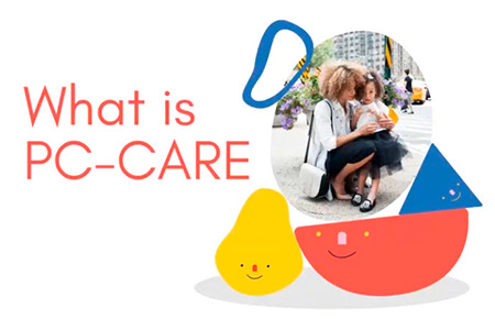 A photo of a woman holding a child and there are large illustrated cartoon toy blocks