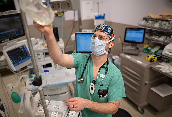 Male anesthesiologist in the operating room