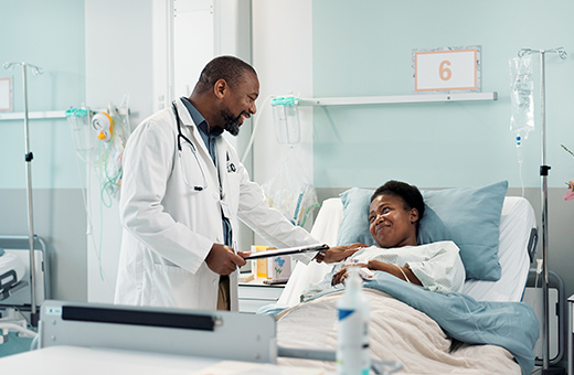 Health care provider checking on patient after pacemaker.