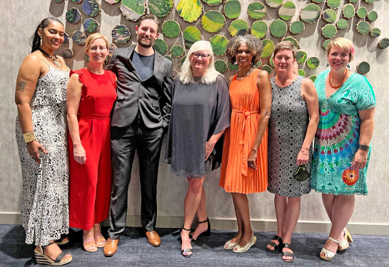 Heather Young, center, stands flanked by fellows from inaugural cohort