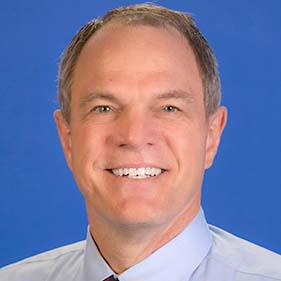 White male with gray hair in a physician white coat