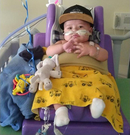 Baby patient sitting up in bed