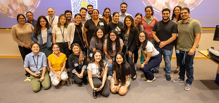 About 30 medical students, residents, staff and faculty pose for a group photo with California Surgeon General Diana Ramos