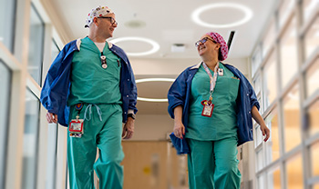 Matthew and Cindy walking down a hospital hallway