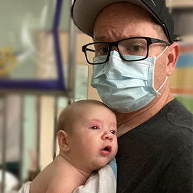 Matthew masked holding Ellie