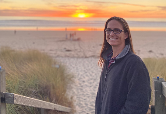 Leslie Peek alone with beach in background