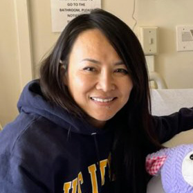 Asian woman in sweatshirt. 