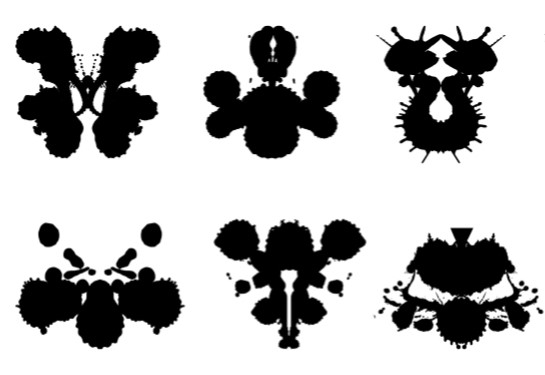 Black Rorschach blots are seen against a white background