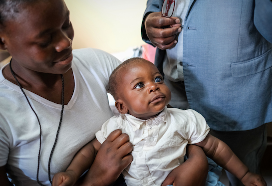 A woman holds a baby on her lap at the University Teaching Hospital &#x2013; Eye Hospital in Lusaka, Zambia. 