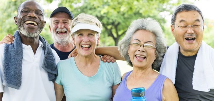 A group of senior adults stand together after exercising