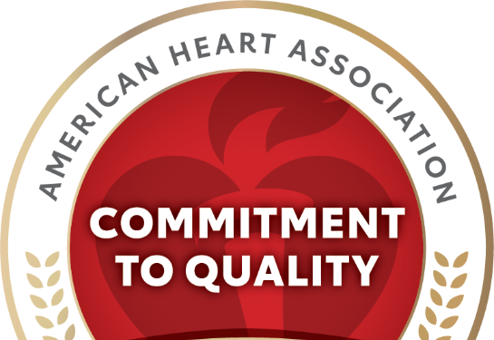 Round logo with a heart in the middle that says commitment to quality in the middle.