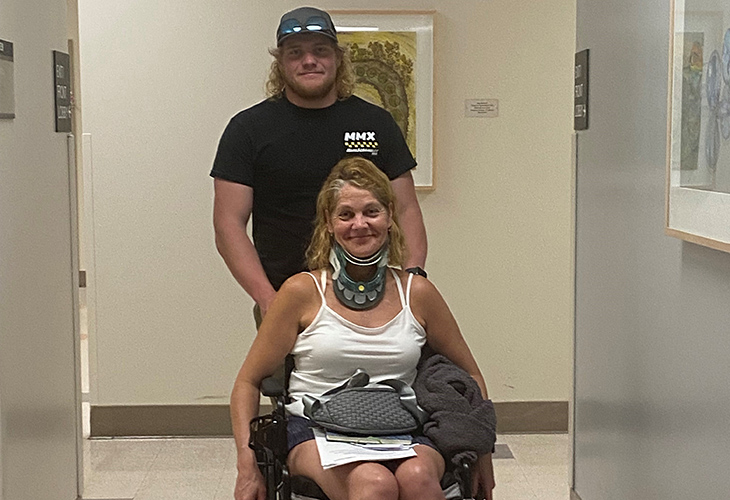 Ben is pushing the wheelchair of his mom Patti Dailey.