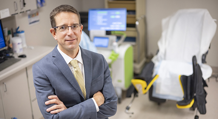 image of male doctor standing in exam room portrait 