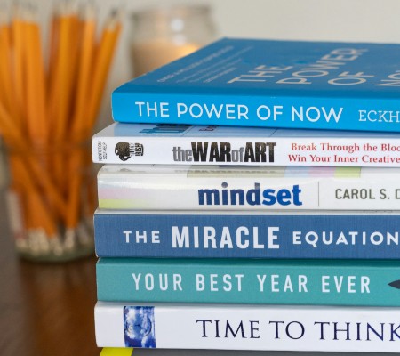 Stack of self-help books in shades of blue 