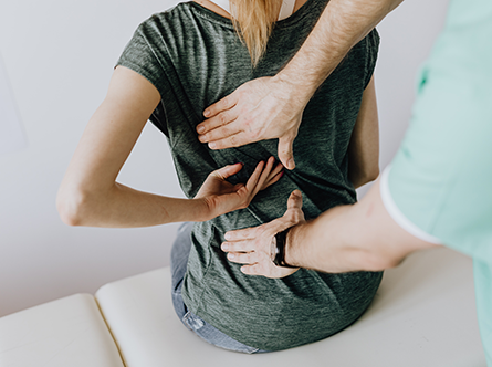 woman showing doctor her back pain