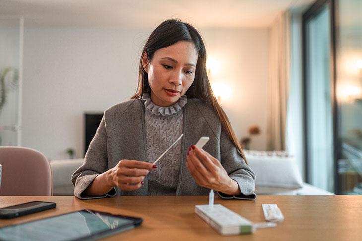 woman taking at-home covid test