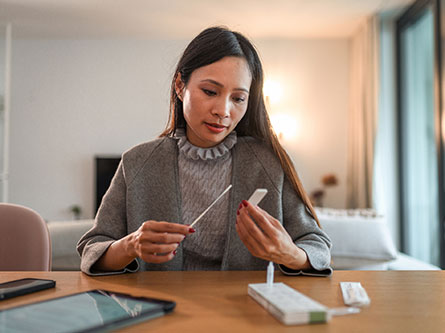 woman taking at-home covid test