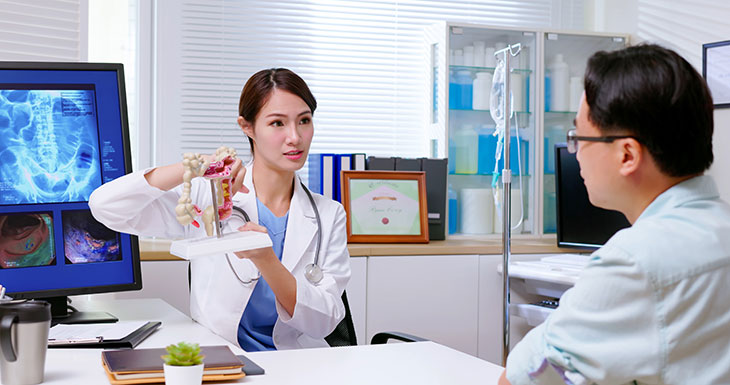 physician talking to a patient about colon exam