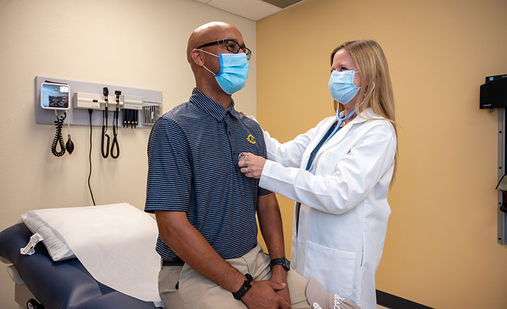 primary care provider listening to patient's heart