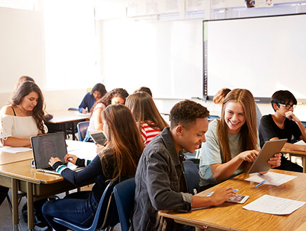 high school students at desks working together