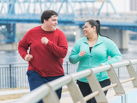 overweight man and woman walking