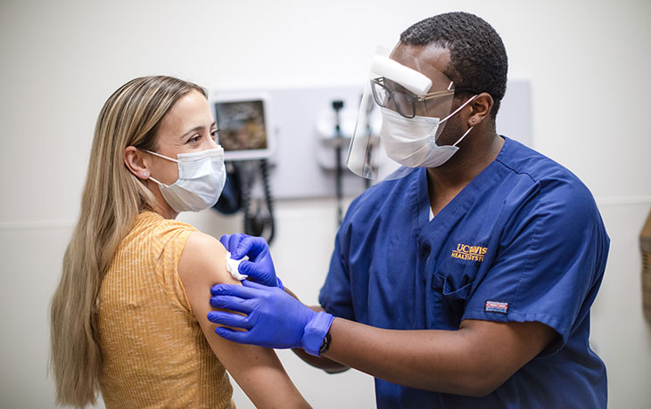 Nurse giving woman a shot