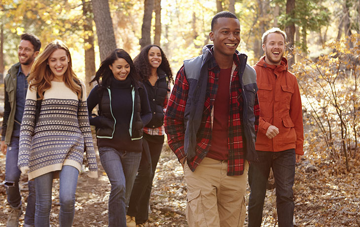 Group of friends walking together in the woods