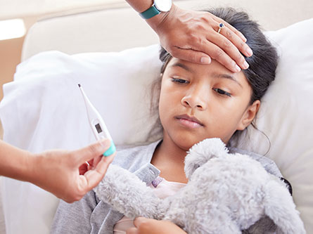 girl sick with measles symptoms