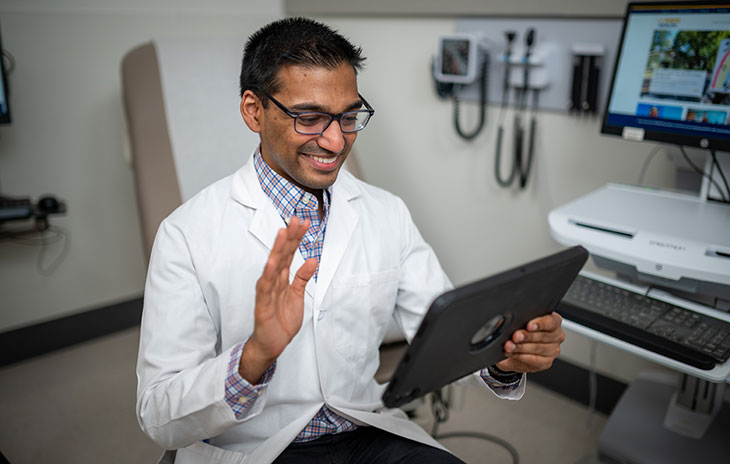 health care provider on a tablet talking with a patient via telehealth