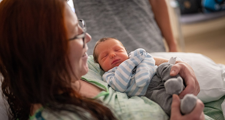 A mother holding a newborn baby