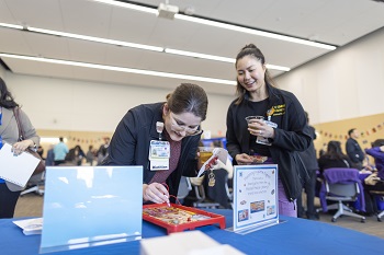 Attendees participate in table activities hosted by UC Davis Health Employee Resource Groups