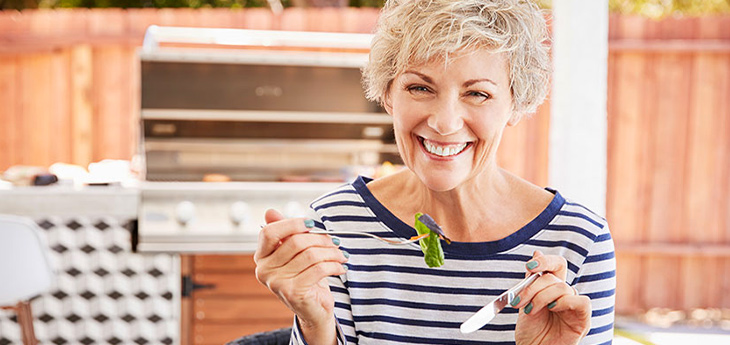 older woman eating a salad