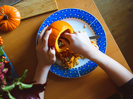 Pumpkin cut open and being cleaned out
