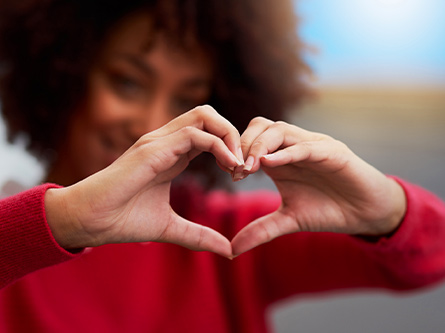 Woman makes a heart with her hands