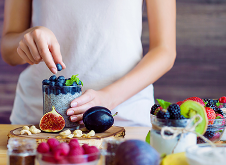 woman putting berries in a bowl