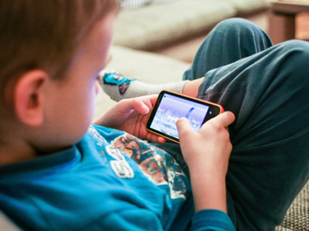 child looking at a mobile phone