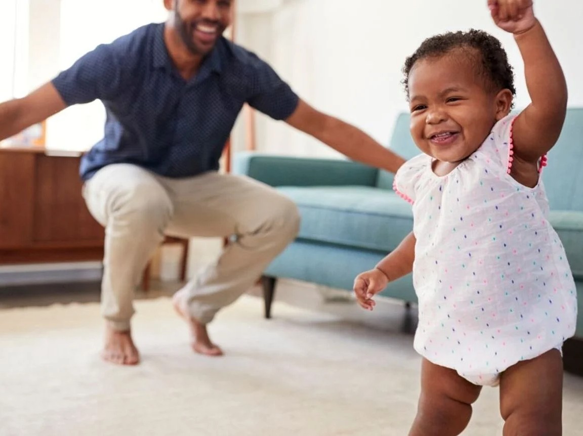 smiling toddler and father