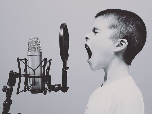 kid yelling into microphone