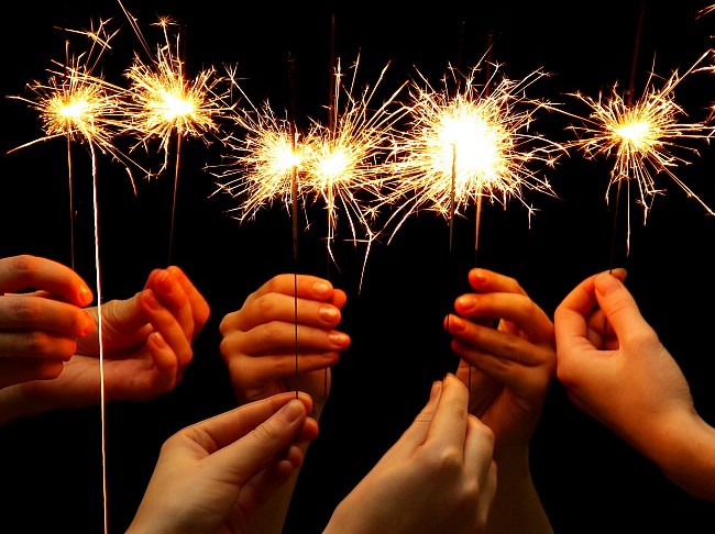 hands holding sparklers