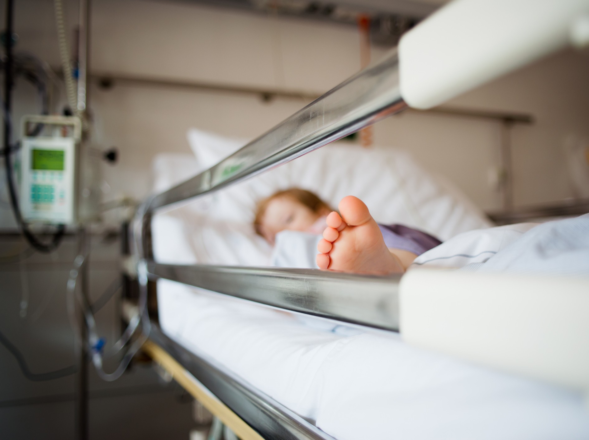 kid laying in hospital bed