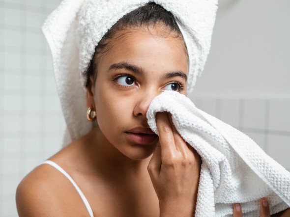 teen washing face