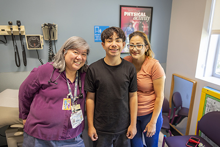 Justin and his mom at a recent visit with his doctor, Stephanie Tram-Anh Nguyen.