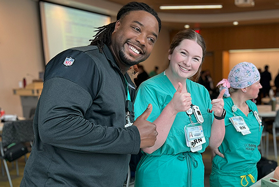 New Graduate Nurse Residency Program participants giving a thumbs up. 