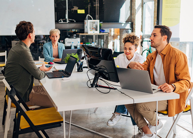 Group of programmers work in pairs and learn to code programs together