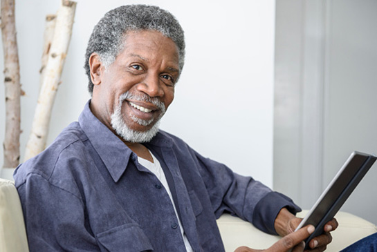  A man holding a computer tablet.
